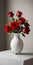 Red roses vase on white table light background