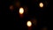 Red round burning funeral candles on sand in a catholic temple. Candlelight in dark defocus