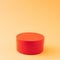 Red round gift box on ocher and orange background with copy space. Advertisement idea. Minimal banner ad concept