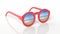 Red round-lens sunglasses with sandy beach reflection on lens