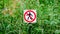 Red round prohibition sign with a black silhouette of a man crossed out. Prohibition to walk on the grass. Panoramic format