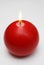 Red round shining candle on a white background