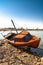 Red rowboat lying at shore