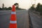 Red rubber cones are placed in the paved road