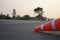 Red rubber cones are placed in the paved road