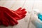 Red rubber gloves and liquid detergent