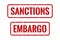 Red rubber print of Embargo and Sanctions text with dirty texture. Embargo and Sanctions stamp