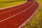 Red rubberized running track during autumn season