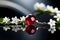 Red ruby shining, and white jasmine on black table