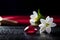 Red ruby shining, and white jasmine on black table
