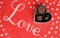 Red rug with the word Love scripted across top and trio of chocolates