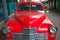 Red russian retro car Pobeda Victory standing in the street