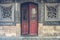 The red rustic door on balck rustic wall