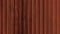 Red rustic ribbed metallic surface loop. Wavy iron wall pattern. Fluted metal fencing backdrop. Corrugated metal texture. Crimp
