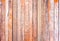 Red rustic woodden board with knots and nail holes, vintage bac
