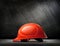 Red safety helmet on steel