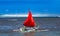 Red sail on a traditional wooden boat in Bali