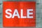Red sale sign / banner inside window display