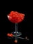 Red salmon caviar in a glass vase on a black background with ref