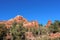 Red sandstone mountains with evergreen trees on the Boynton Canyon Vista Trail in Sedona, Arizona