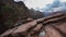 Red sandstone mountains with juniper tree and rain storm.