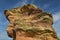 Red sandstone rock strata with blue sky and striped clouds. Caiplie Caves, Crail, Fife, Scotland, UK.