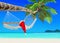 Red Santa Claus hat on hammock at palm island beach