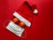 Red santa claus hat, tangerines instead of eyes and medical mask on red background