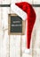 Red Santa hat and chalkboard. Christmas decoration Happy Holiday