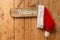 Red Santa hat hanging on a welcome sign on an old front door