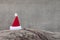 Red Santa hat on trunk for christmas - wood background for a greeting card