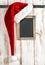 Red Santa hat and vintage chalkboard. Christmas decoration