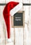 Red Santa hat and vintage chalkboard. Retro christmas decoration