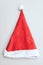 Red santa hat with white bubo and edging on a light background