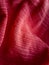 Red satin cloth. Wavy fabric texture