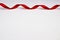 Red satin ribbon on white background