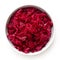 Red sauerkraut in a white ceramic bowl isolated on white. Top view