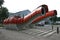 Red scaled and paneled facade in undulation of Kumutoto Toilet on Synergy Plaza on Queens Wharf, Wellington CBD, New Zealand