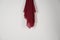 red scarf hung on the wall. Thin fabric texture is commonly used for fashion materials.