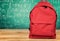 Red school bag on background