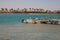 Red sea beach and boat near pier