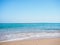 Red Sea photographed from beach, long view. Sea foam on brown sand. Blue sky is clear. Egypt in february, nature