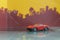 Red Sedan car toy selective focus on blur city background