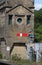 Red semaphore railway signal on station platform.