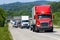 A red semi leads a line of traffic down an interstate highway in Tennessee