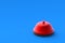 Red service bell in corner on blue background. Administrator call. Copy space