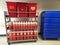 Red sharps containers on rack in hospital hallway