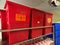 Red sharps containers on rack in hospital hallway