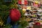 Red shiny ball on the Christmas tree against the background of defocus shelves in the store. Concept Christmas holiday sale New