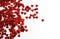 Red shiny confetti hearts on a white background